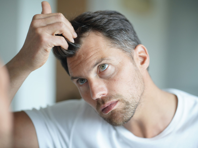 a man checking his hair
