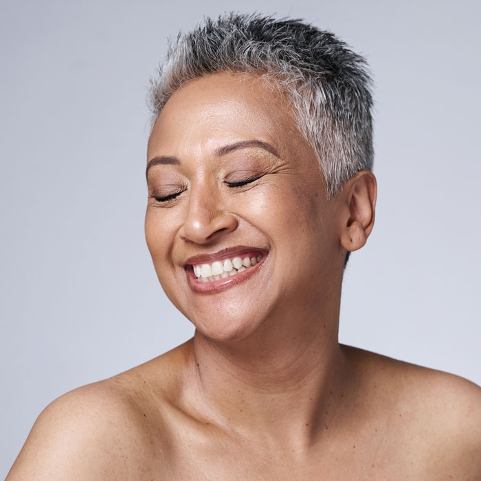 mature woman smiling with eyes closed